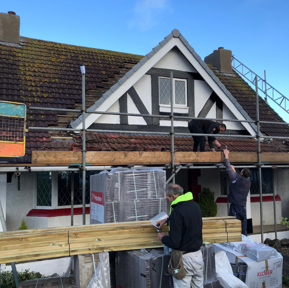 Majestic Roofing staff working on house roof.