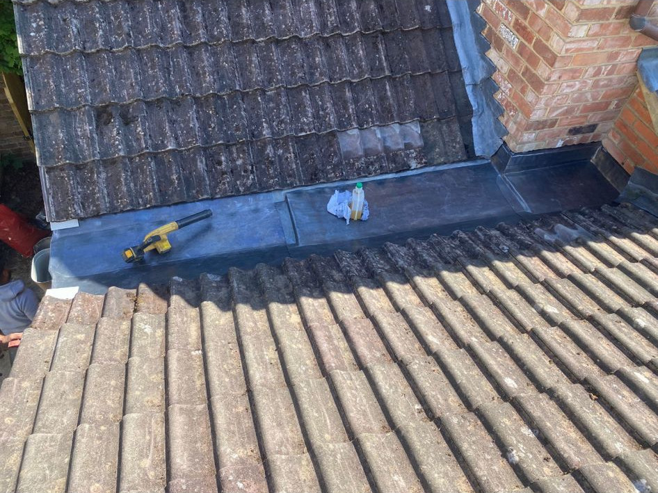 Example of properly dressed leadwork for chimney flashing.